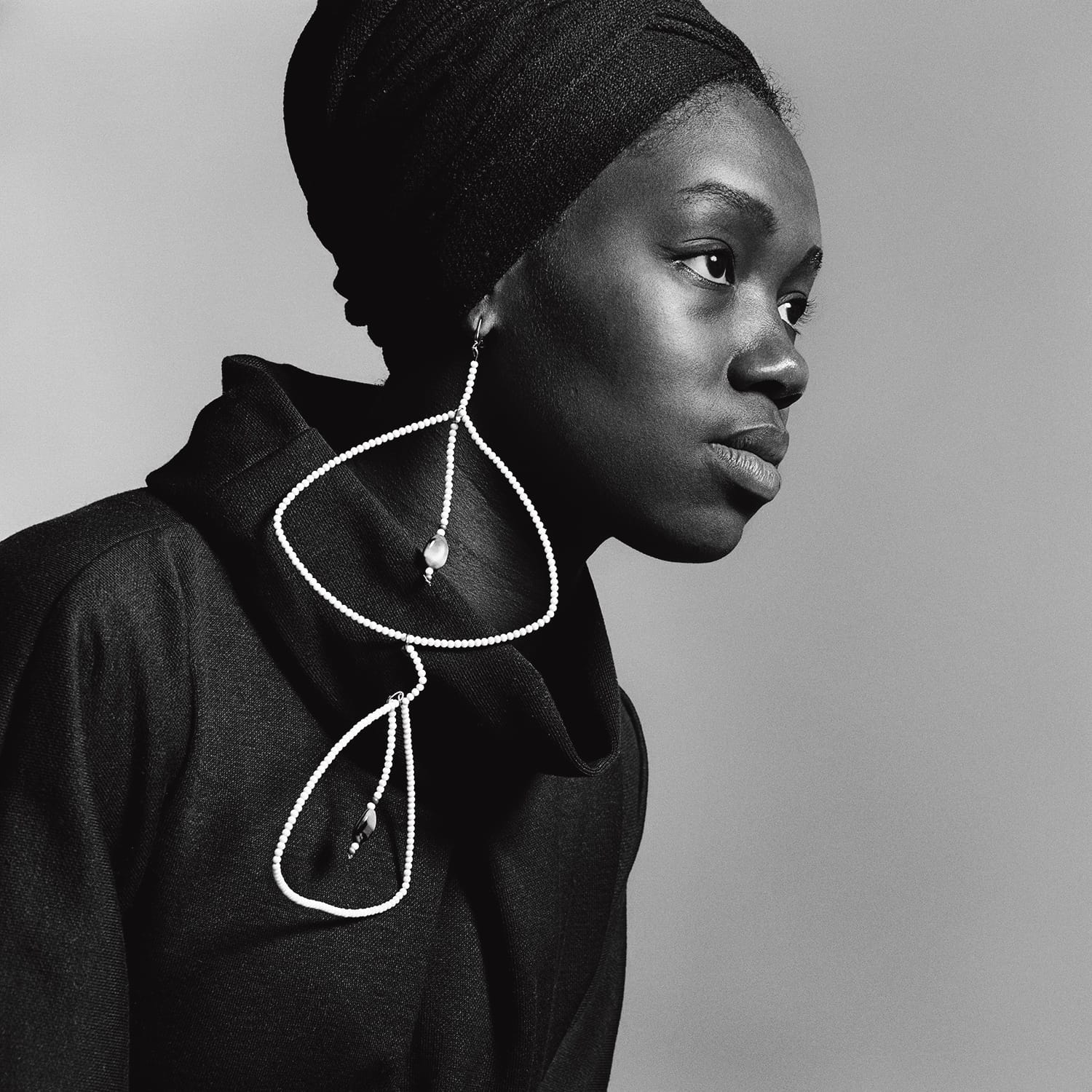 Image of Nomsa Brath wearing earrings by Carolee Prince. Taken by Kwame Braithwaite ca. 1964